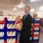 Goodman Fielder managing director Peter Reidie holds one of the Christmas hams stored at the new...