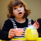 Grace Hughes from Dunedin plays with a tea set. Photo by Stephen Jaquiery.