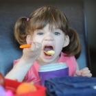 Grace Hughes has a mouthful of her new favourite food, vanilla custard - the first time she has...