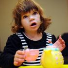 Grace Hughes, of Dunedin, who has never eaten solid food, plays with a tea set. Photo by Stephen...