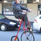 Graeme Simpson rides a pennyfakething along Thames St yesterday. Photo by Sally Rae.