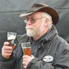 Graham Scott, of Dunedin, tastes beers at the Dunedin Craft Beer Expo at Dunedin Railway Station...