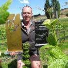 Grasshopper Rock vineyard manager and viticulturalist Mike Moffitt celebrates the vineyard's...