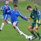 Green Island's Tennesse Kinghorn tries to evade Mosgiel's Jesse Wright, who has Aaron Corkill in...