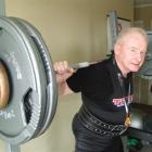 Greenfield powerlifter Bruce Park puts some muscle into the lifting in his home gym yesterday....