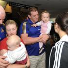 Greeting each other at the Dunedin International Airport yesterday are (from left) Jason...