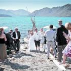 Guests wish Catherine Lyness and Nigel Anderson well after they were married on a Lake Wanaka...