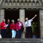 Guide David Horne describes the facade of St Paul's Cathedral to Eva Eaton, Margaret Tagg, Helen...