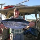 Haast commercial fisherman Kerry Eggeling with a tuna caught on Wednesday. Photo by Marjorie Cook.