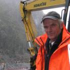 Haast digger driver Peter Shields (52) with the machine he used to retrieve the body of Ashish...