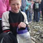 Hamish Kennedy (10) prepares to release salmon fry into the Kakanui River. Photo by Sally Rae.