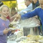 Forbury School (Dunedin) pupil Barbie Taylor (10) is served vegetables and meat by school...