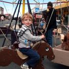 Cameron Marriott (4) enjoys a ride on the merry-go-round at the South Dunedin Street Festival on...