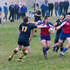Harbour's John Leslie Legg fends off a Dunedin tackler, with Sam Ready in support, at Kettle Park...