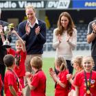 Henry Craig (7), of the Clutha Rippa rugby team, holds up the trophy, watched by team-mates and ...