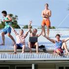 Having a blast on the roof of a Dundas St flat are (from left) Mitch Lalor (20), of Methven,...