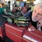 Hayward's Auction House auctioneer Kevin Hayward, of Dunedin, inspects a hand-built live steam...