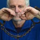 Hayward's Auction House owner Kevin Hayward holds shackles set for auction next week. Photo by...