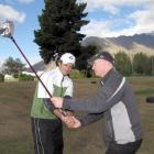 Head golf pro Jamie McIsaac (right), from Queenstown Golf Club, coaches Richard Middleton, of...