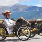 Heikki Kaariainen cycles on the Crown Range Rd, above the harrowing paddock which he crashed into...