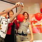 Helen Clark poses for a photograph with two students at the University of Otago common room...