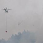 Helicopters battle the fire. Photo by James Beech