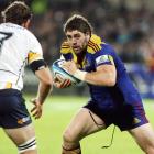 Highlanders captain Jamie Mackintosh on the charge towards  Brumbies  openside flanker Julian...