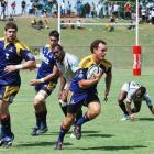 Highlanders fullback Israel Dagg moves upfield with forwards Jamie Mackintosh (left) and Joe...