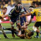 Highlanders No 8 Nasi Manu busts through the Hurricanes defence. Photo Getty Images