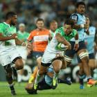 Highlanders second five-eighth Rob Thompson offloads to winger Ryan Tongia to set up the first...