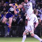 Highlanders wing Ben Smith grabs at a high ball ahead of Stormers counterpart Gcobani Bobo in...