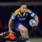 Highlanders wing Hosea Gear breaks the tackle of Chiefs fullback Robbie Robinson during their...