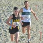 Hill City runner Oliver Chignell leads Eddie Smith (Ariki) during the open men's race of the...