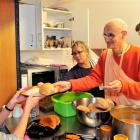 His Holiness Janananda Swami dishes up a $3 Hare Krishna lunch to Rika Takeda (19) at the Otago...