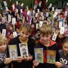 Holding the colourful cutout All Blacks they have coloured in to be sent to schools in Argentina,...
