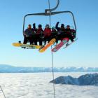 Snowboarders take the chairlift to the top of Treble Cone, Wanaka. PHOTO: SUPPLIED