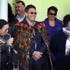 Hone Harawira, dressed in a feather cloak (korowai), is welcomed on to Rawhitiroa kura kaupapa...