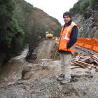 Horrell Contracting foreman Dave Kenny stands on rock overhanging Manuka Stream, which flooded...