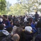 Hundreds of migrants wait  at Berlin's central registration  centre for refugees and asylum...