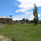 Ian and Kirsten Knights' house, seen here between the large tree and power pylon to the right of...