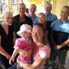 Ciara Hovey (2) and her mum, Jane Hovey, are surrounded by Oanaka Educare Centre workers before...