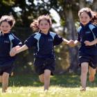 Identical triplets (from left) Olivia, Charlotte and Haylee Kelly (6) are glad to be back for...