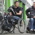 Importer Shanon Arnold (left) in the Striker hand bike with tetraplegic Keith Jarvie, who is...