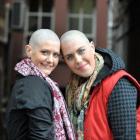 Caitlin Dunstan-Harrison (left) and Hannah Langford-Berman, with their freshly-shaved heads, pose...
