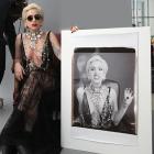 In this publicity image released by Polaroid, Lady Gaga poses with a large Polaroid picture of...