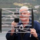 In tune . . . Aerial and television installer Ross Griffiths holds up a new high definition UHF...
