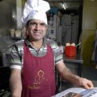 Indian chef Madhavlal Chaudhari takes time off cooking curry to practise his reading. Photo by...
