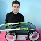 Industrial designer Stuart Smith (23) with his solar-powered lawn mower model  which is in the...