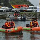 Inflatable rescue boat squad members (above, from left) Jamie Walters, Seth McPhee, Mark Whelan...