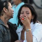 Inmates' relatives stand outside a prison after a fire which killed more than 350 inmates broke...